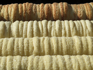 Trdelnik, traditional national czech dessert, baking on the street of Prague