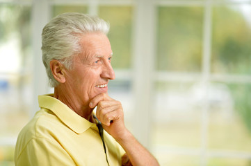 Portrait of thoughtful senior man at home