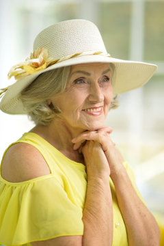 portrait of beautiful senior woman in yellow dress