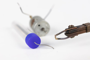 Repair of a small electric motor. Simple soldering work in the electronics workshop.