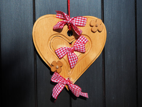Wooden heart with red and white bow