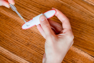 Pregnancy test in woman's hand. Shallow depth of field.