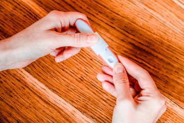Pregnancy test in woman's hand. Shallow depth of field.