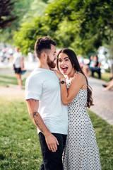 Handsome guy hugging his girlfriend in the park.