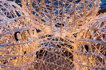 Christmas lights of garland in the form of a ball, cream color, background.