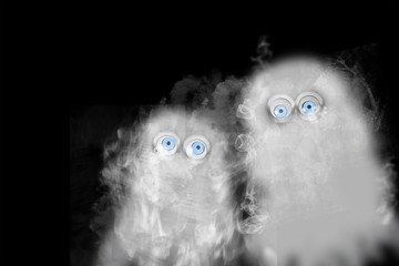 Two ghosts on black background with copy space