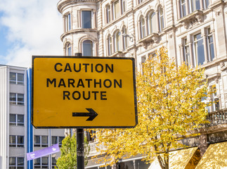 Fototapeta na wymiar Caution Marathon Route. Sign with arrow