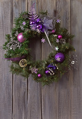 Lovely Christmas handmade ornaments. Wreath made of natural materials and tinsel.