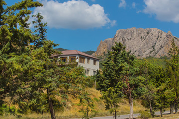Fototapeta na wymiar house near a road in a mountainous area
