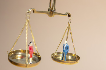 Depicted in a conceptual image by  a seesaw showing the male and female genetic symbols in equilibrium. Equality between the sexes.   Feminism and equality