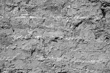 Black and white wall of brick and concrete layer