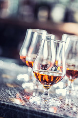 Cups with a cognac rum brandy or whiskey drink.