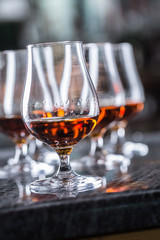 Cups with a cognac rum brandy or whiskey drink.