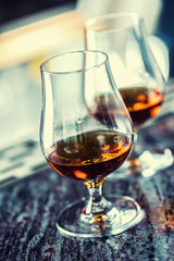 Cups with a cognac rum brandy or whiskey drink.