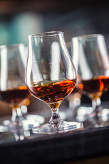 Cups with a cognac rum brandy or whiskey drink.