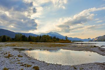 Beautiful landscape with lake, mountains, forest, clouds and reflection in water. Austria, Salzkammergut, Wolfgangsee