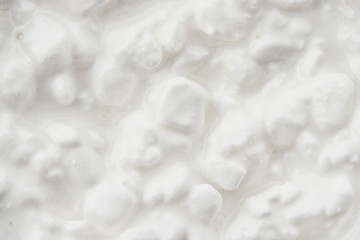 Grained cottage cheese top view close up