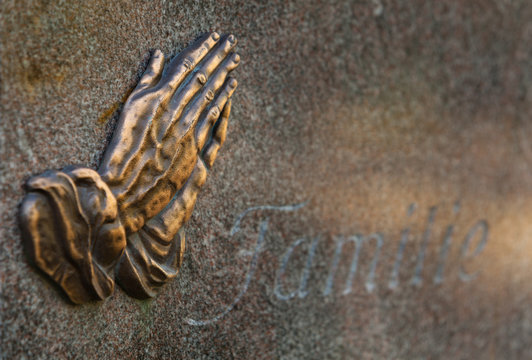 Folded Hands (after a Painting by German Artist Albrecht Duerer) on a Gravestone of a Family ("Familie")
