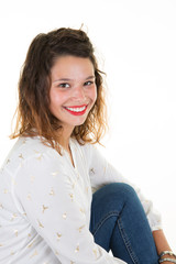 Portrait of cheerful beautiful teenager girl in jeans