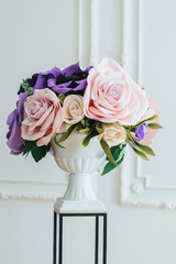 Wedding decor concept. Beautiful flowers made in bouquet in vase on stand isolated over white background. Floral concept. Festive event