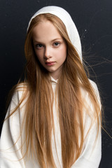 Portrait of beautiful young redhead girl posing in studio.