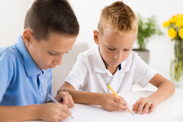 Little boys having fun and coloring at home