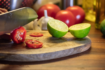 Chopping chili on wooden cutting board