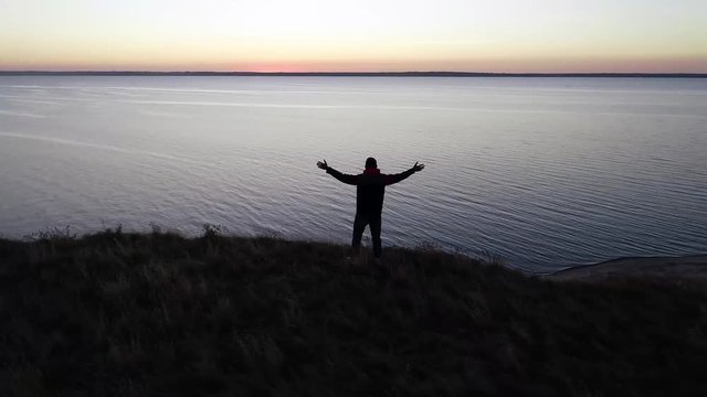 guy on top of mountain hands to heaven nature meditation air. Circumventing the camera