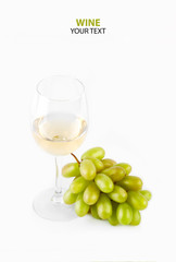 A glass of white wine with a bunch of green grapes on a white background. Alcoholic beverages.
