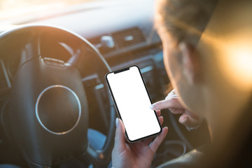 Woman uses a smartphone while driving at the wheel. Template, mockup.