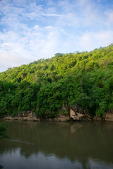 Fototapeta na wymiar mountain slope on jungle river 