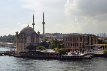 Fototapeta na wymiar View of Ortakoy square, famous historical mosque and people in a sunny summer day in Istanbul.