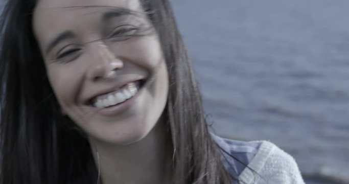 Close up of a beautiful woman shaking head and smiling to camera 