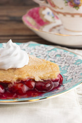 Slice of Homemade Cherry Cobbler on a Blue Antique Saucer