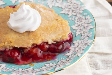 Slice of Homemade Cherry Cobbler on a Blue Antique Saucer