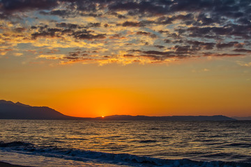 Naklejka premium Early morning , dramatic sunrise over sea and mountain. Photographed in Asprovalta, Greece.