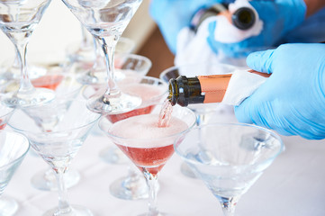 a few wine glasses with champagne, prepared for guests at a party