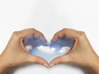 Fototapeta premium Sky in woman hand heart shape on white background