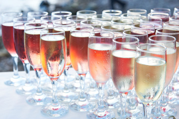 row wine glasses with champagne, prepared for guests at a party