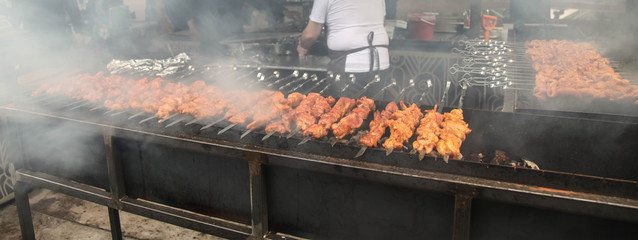 cooking a lot of shish kebab in a street cafe
