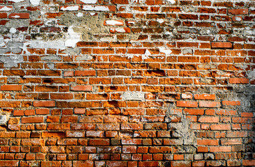 old textured red brick wall  background lit by sun 