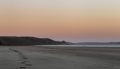 Fototapeta na wymiar Orange Sky Over Scenic Beach in Pembrokeshire