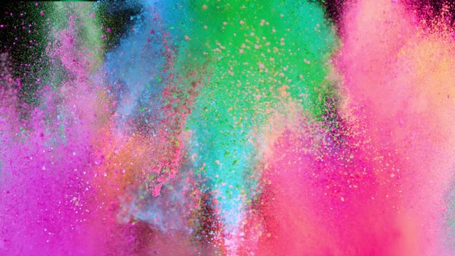 Super slowmotion shot of color powder explosions isolated on black background. Shot with high speed cinema camera at 1000fps