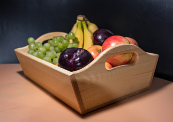 fresh fruits and berries in wooden box, top view