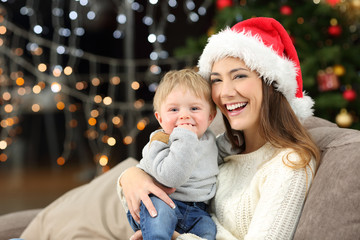 Mother and son looking at you posing in christmas