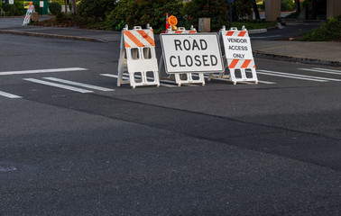 Road closed signs and barricades placed on a crosswalk