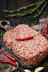 Raw meat with fresh herbs and pink Himalayan salt