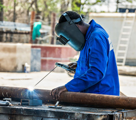 African man worker welding