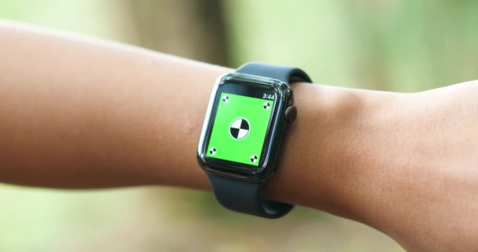 Woman using her green screen smart watch
