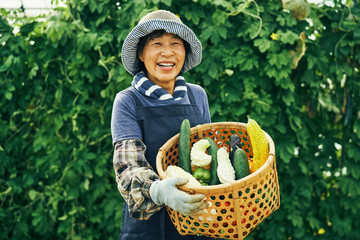 Portrait of woman with basket of vegetables